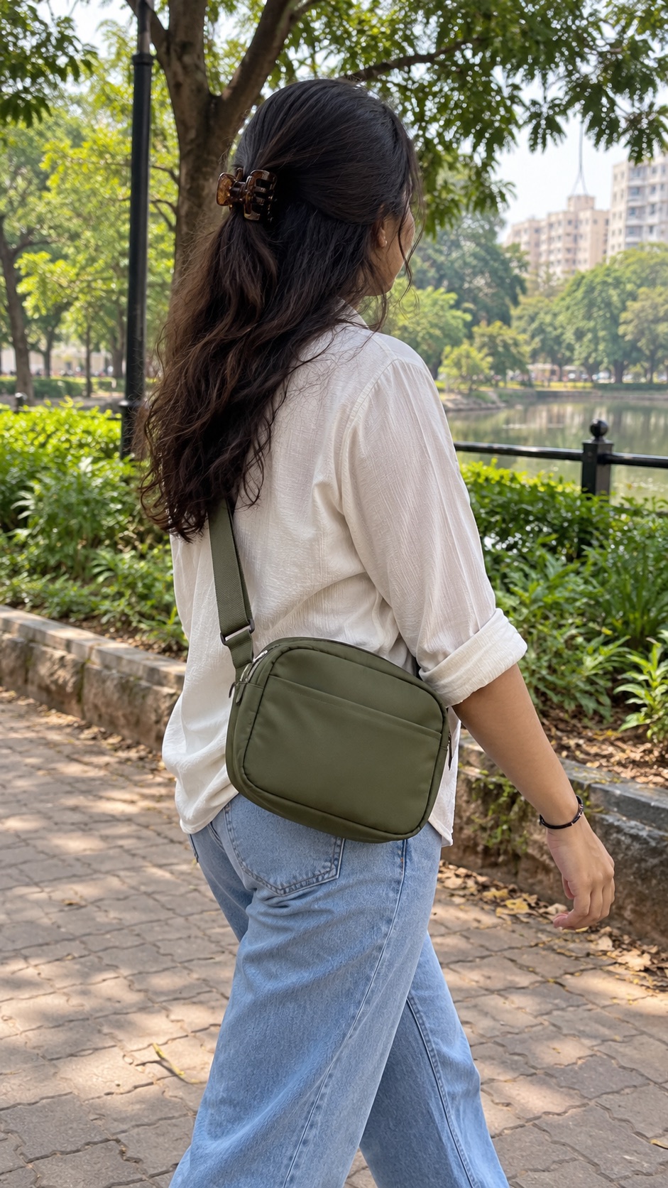An olive sling bag on a weekend walk.